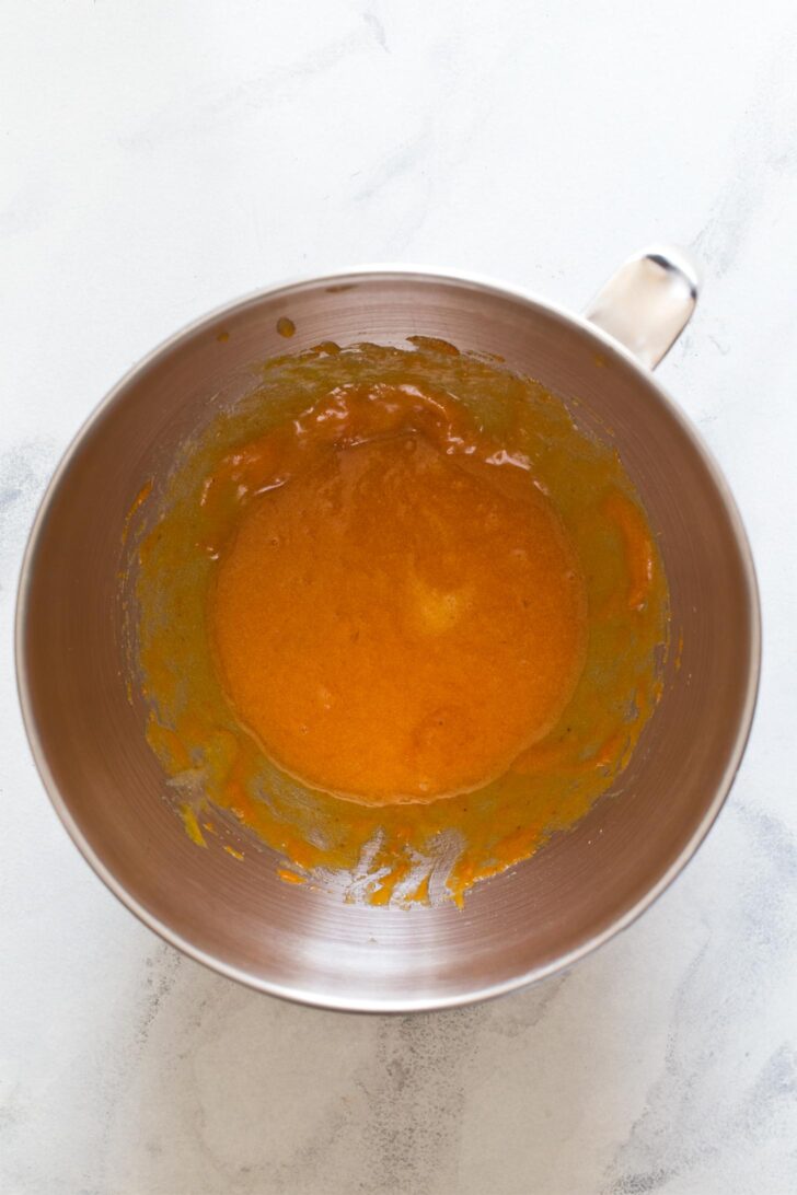 Beating together wet ingredients to make pumpkin biscotti