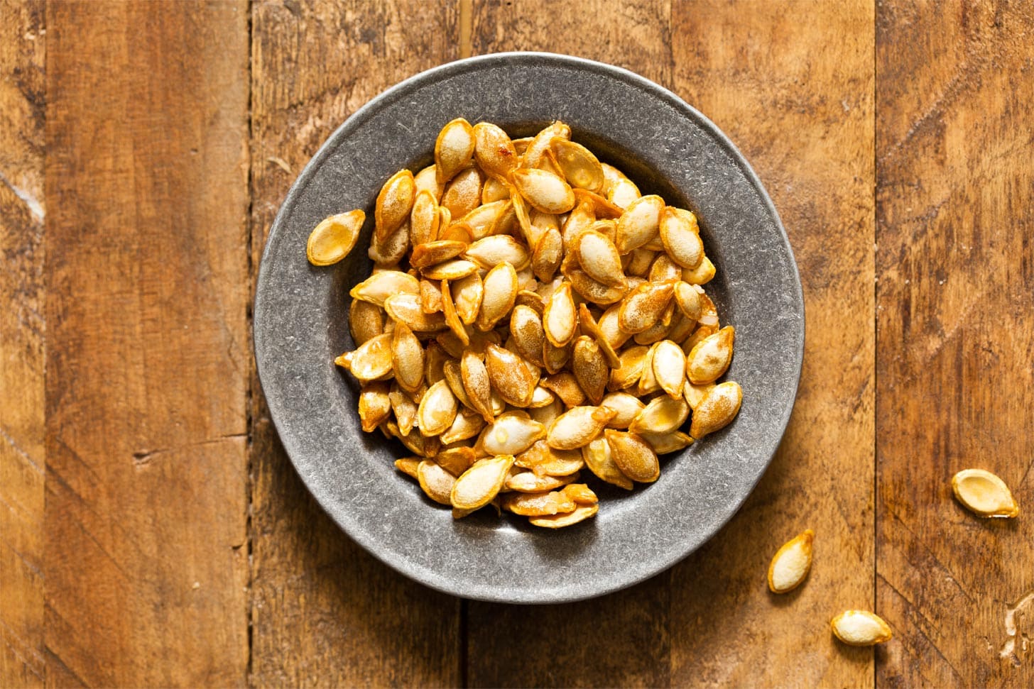 Butternut squash seeds roasted in silver bowl