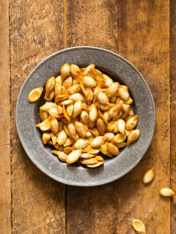 Roasted butternut squash seeds in silver bowl