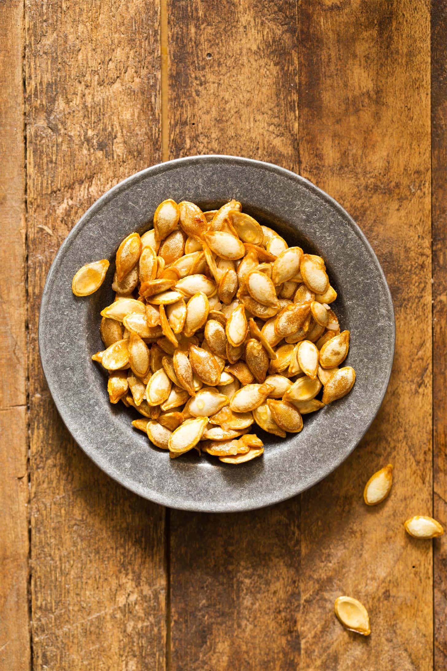 Roasted butternut squash seeds in silver bowl