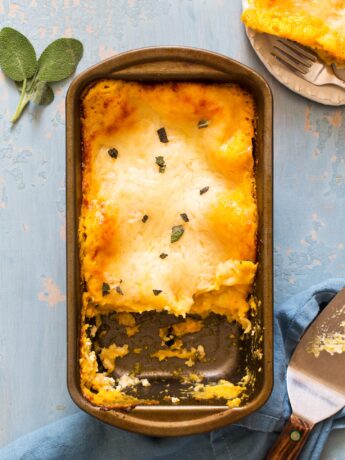 Butternut squash lasagna in a loaf pan with a slice served