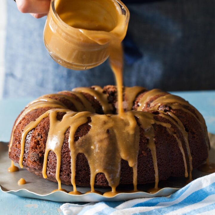 Drizzling caramel glaze over chocolate bundt cake