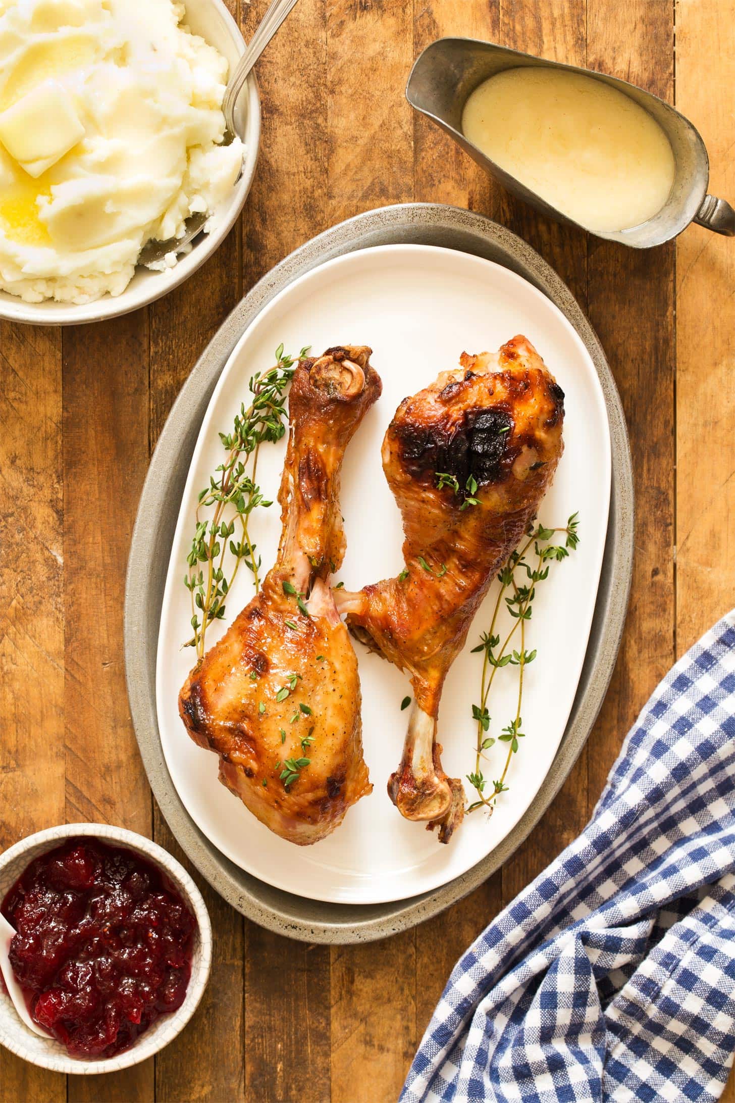 Oven roasted turkey legs on white platter