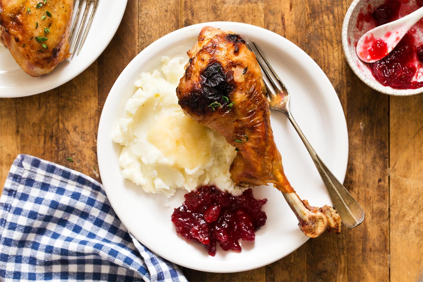 Baked turkey legs with mashed potatoes, gravy, and cranberry sauce