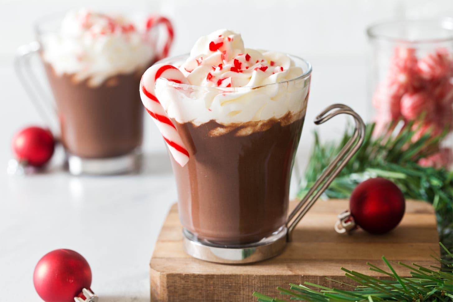 Peppermint homemade hot cocoa garnished with candy cane and whipped cream