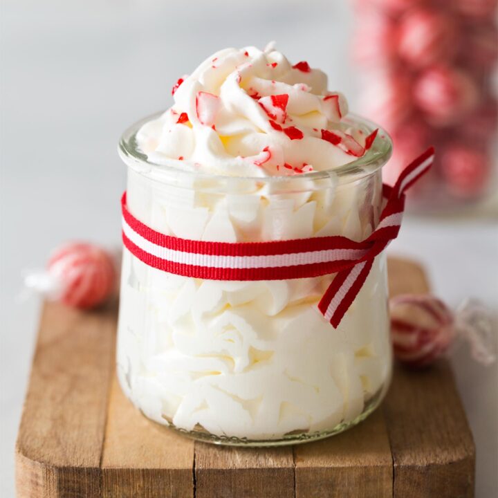 Peppermint whipped cream in a jar with red ribbon