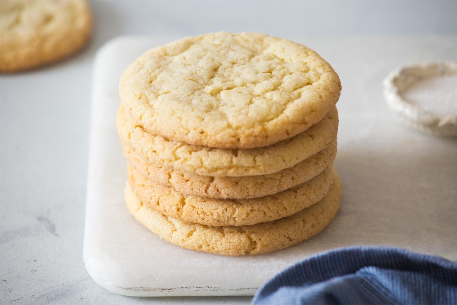 Stack of easy sugar cookie recipe on marble board