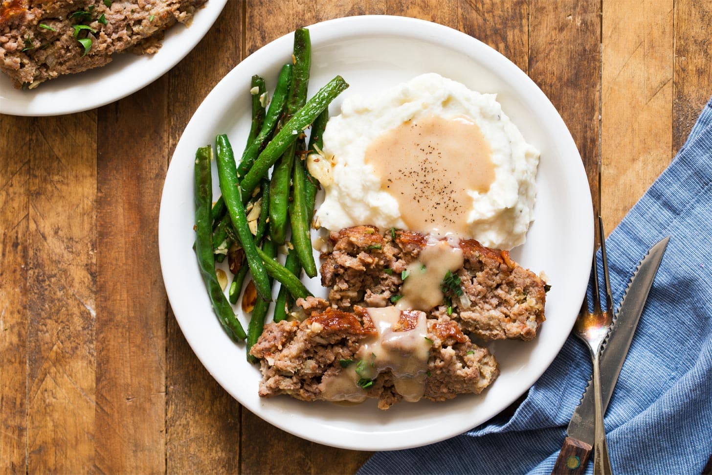 Meatloaf recipe for two with mashed potatoes, gravy, and green beans