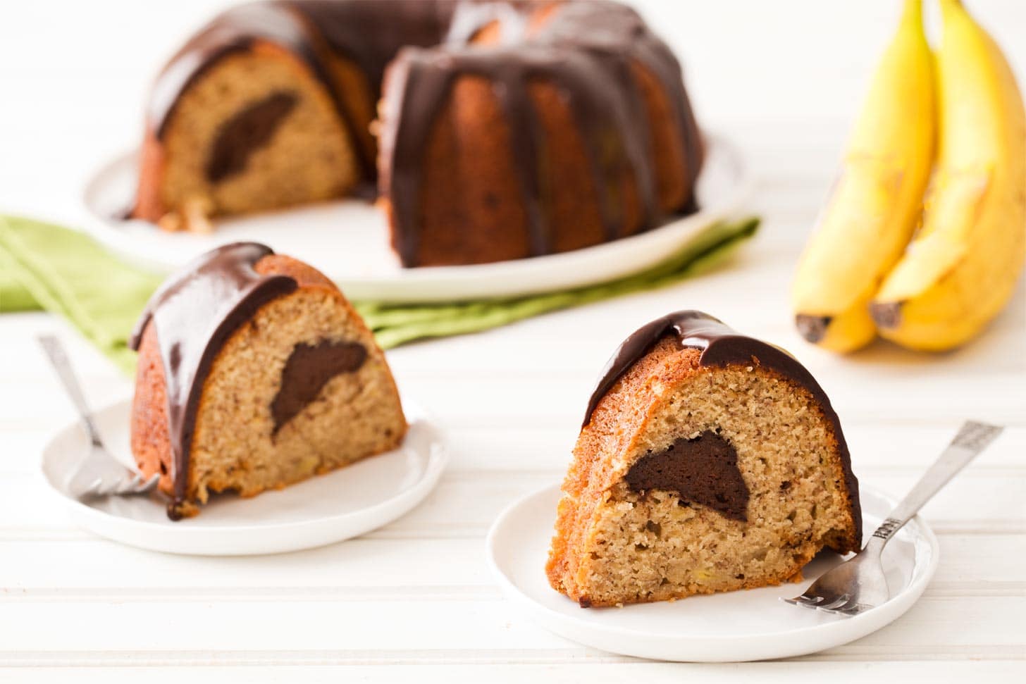 Banana bundt cake recipe sliced and served on white plates