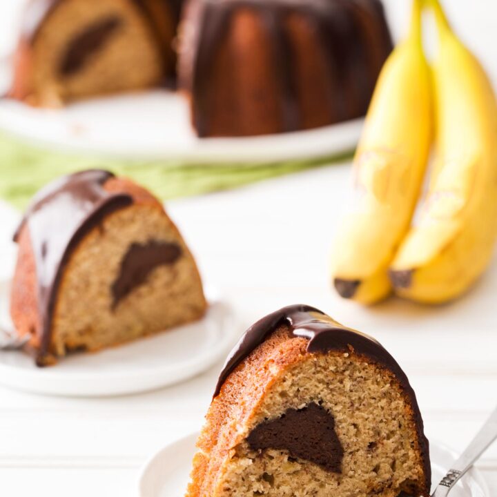 Slices of banana bundt cake with chocolate filling and ganache glaze