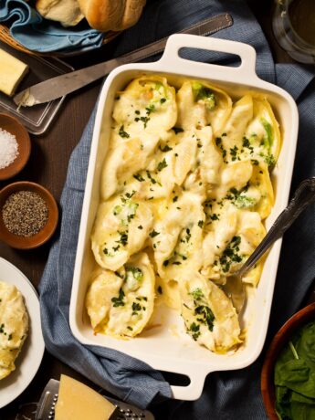 Chicken Alfredo Stuffed Shells served in a casserole dish