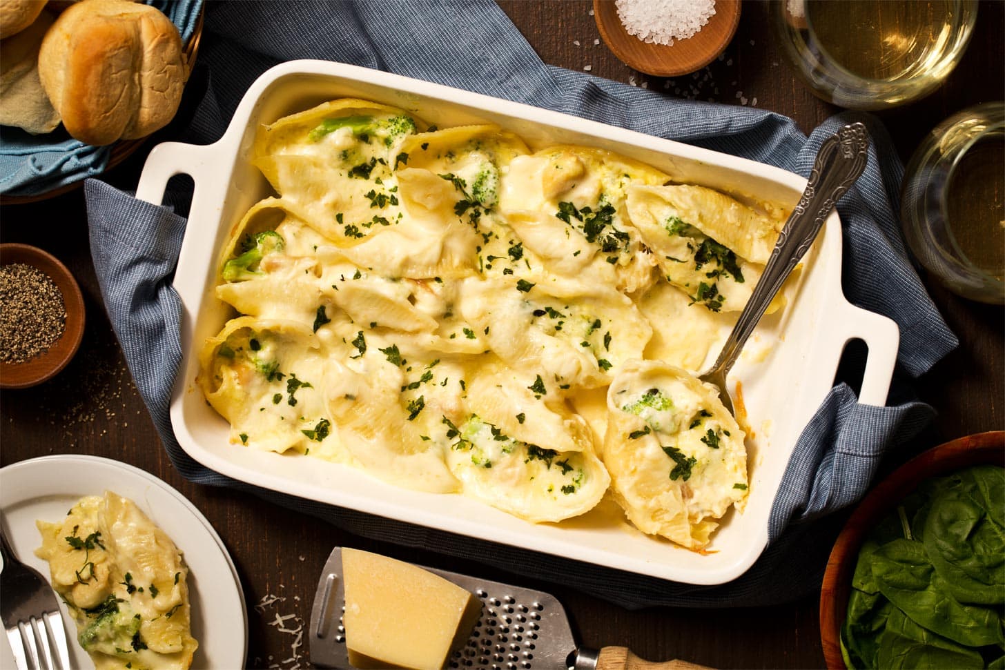 Stuffed shells with chicken and alfredo in white casserole dish