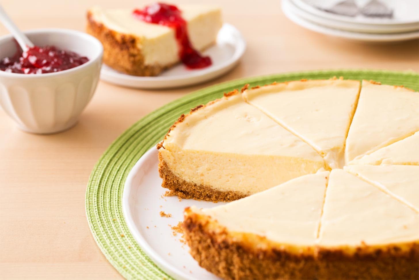 Plain cheesecake with graham cracker crust cut into slices