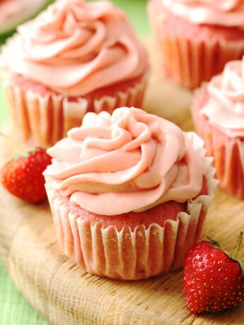 Fresh strawberry cupcakes on a serving board
