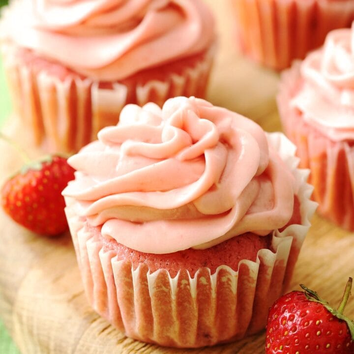 Fresh strawberry cupcakes on a serving board