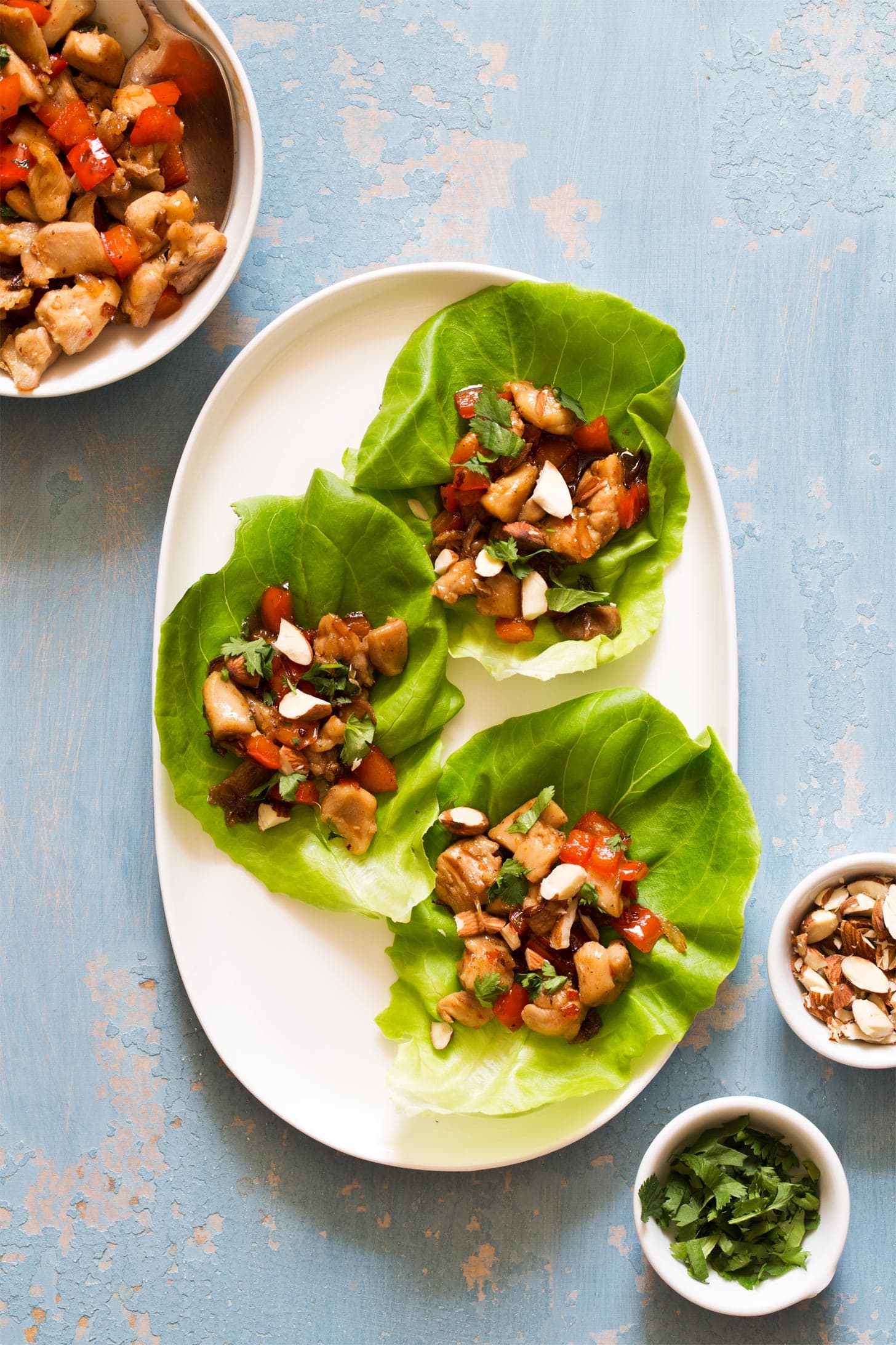 Asian chicken lettuce wraps on a white serving platter