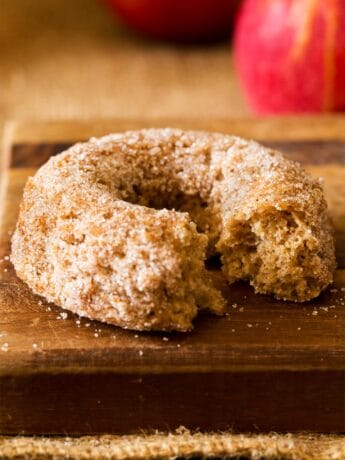 Baked apple cider donut with bite taken out
