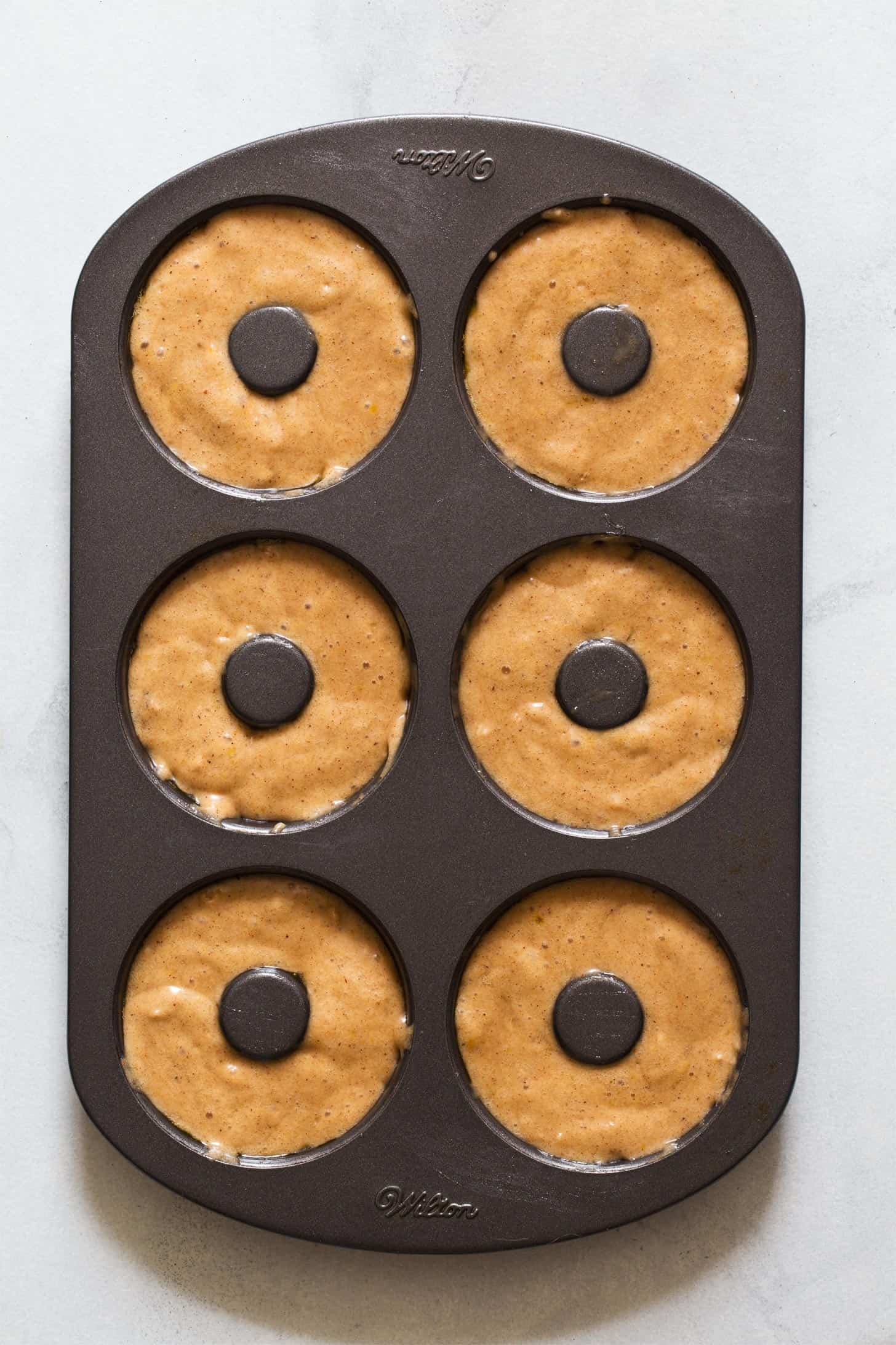 Apple cider donut batter in donut pan